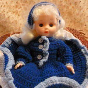 Pretty doll dressed in handmade knitted clothes